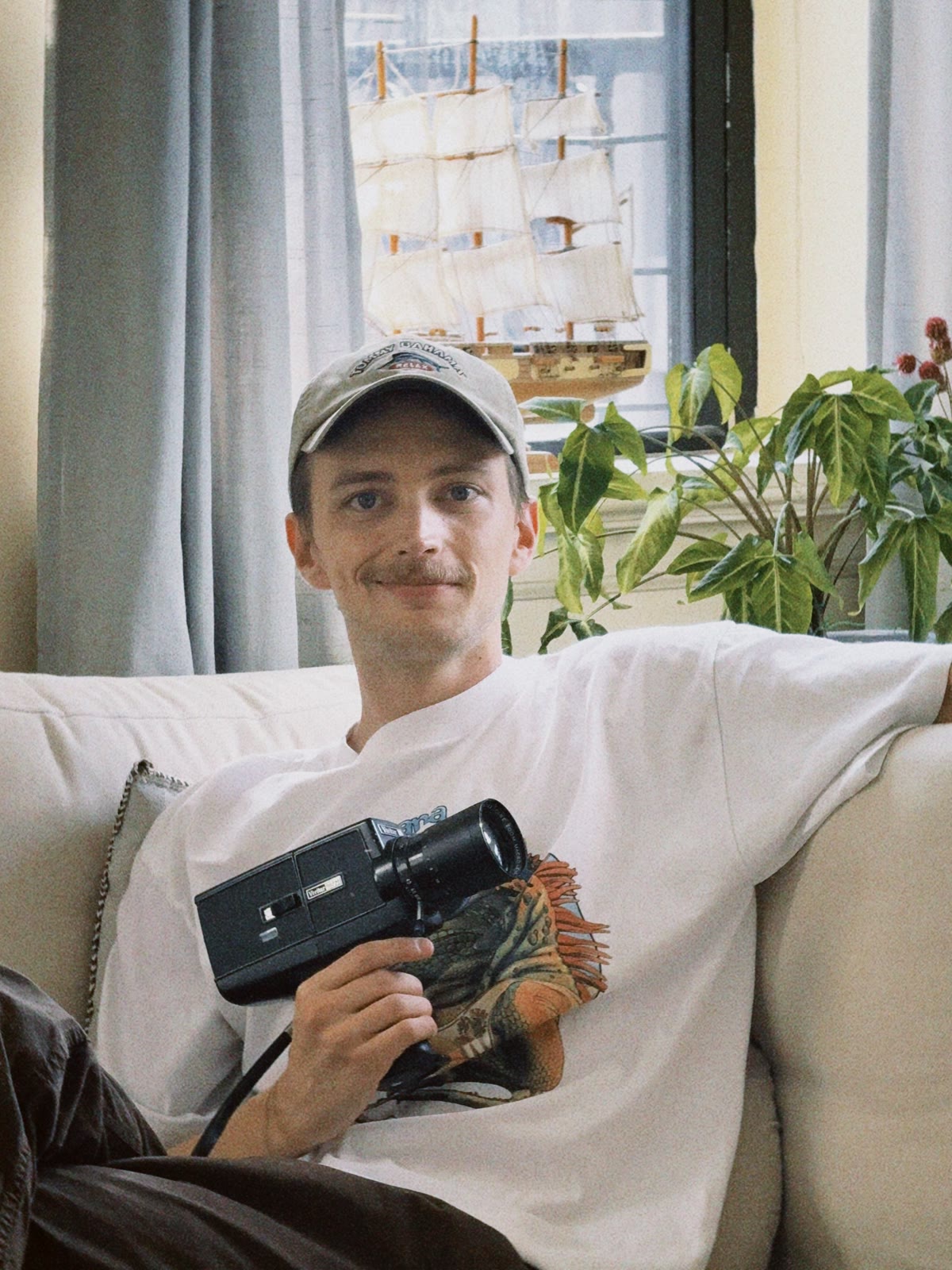 Finley, founder of Corner Slice Weddings, holding a Super 8 camera